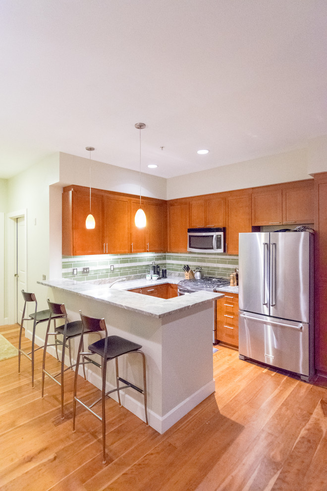 Kitchen - transitional kitchen idea with an undermount sink, granite countertops, green backsplash, stone slab backsplash and stainless steel appliances