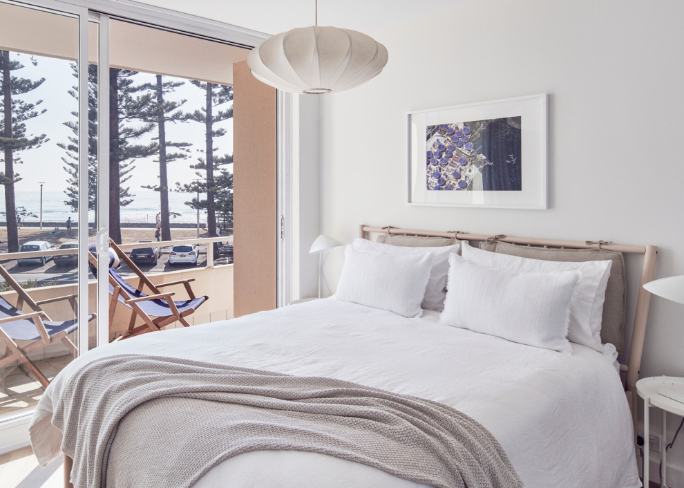 This is an example of a small scandinavian master bedroom in Sydney with white walls.