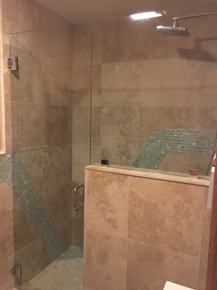 Design ideas for a mid-sized mediterranean 3/4 bathroom in Other with raised-panel cabinets, brown cabinets, an alcove shower, a two-piece toilet, green tile, glass tile, orange walls, travertine floors, an undermount sink, engineered quartz benchtops, beige floor and a hinged shower door.
