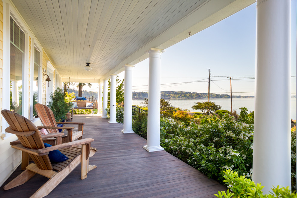 Inspiration for a large country front yard verandah in Seattle with decking and a roof extension.