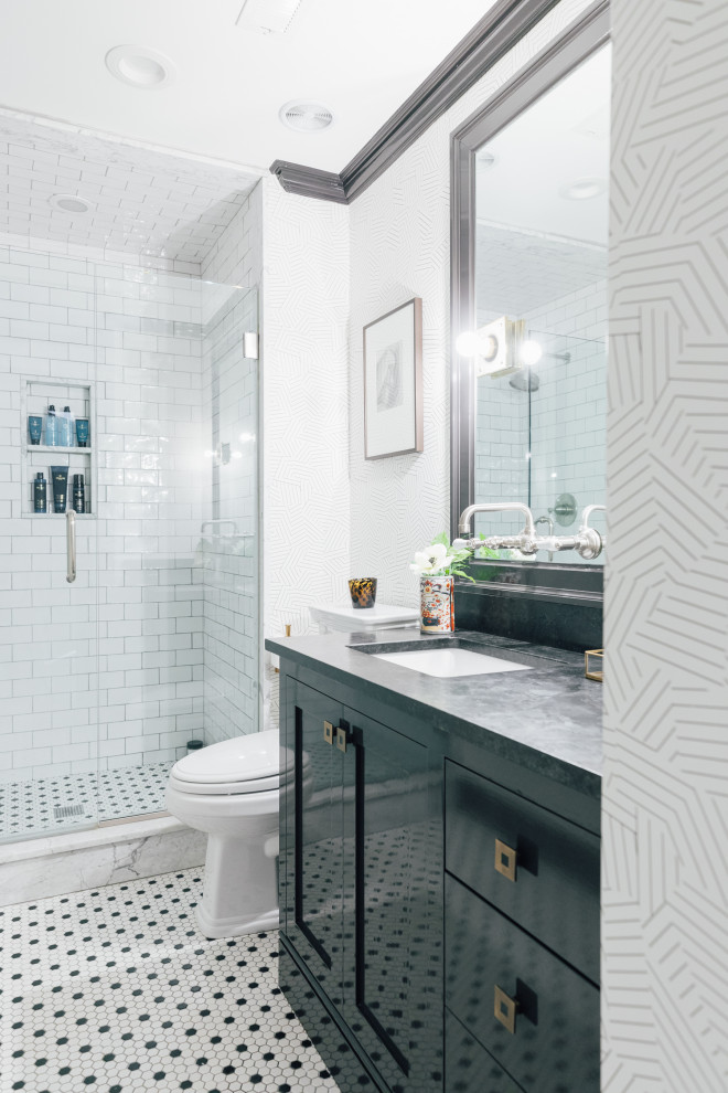 This is an example of a small master bathroom in New York with shaker cabinets, black cabinets, an alcove shower, white tile, ceramic tile, white walls, mosaic tile floors, an undermount sink, marble benchtops, white floor, a hinged shower door, black benchtops, a niche, a single vanity, a freestanding vanity and wallpaper.