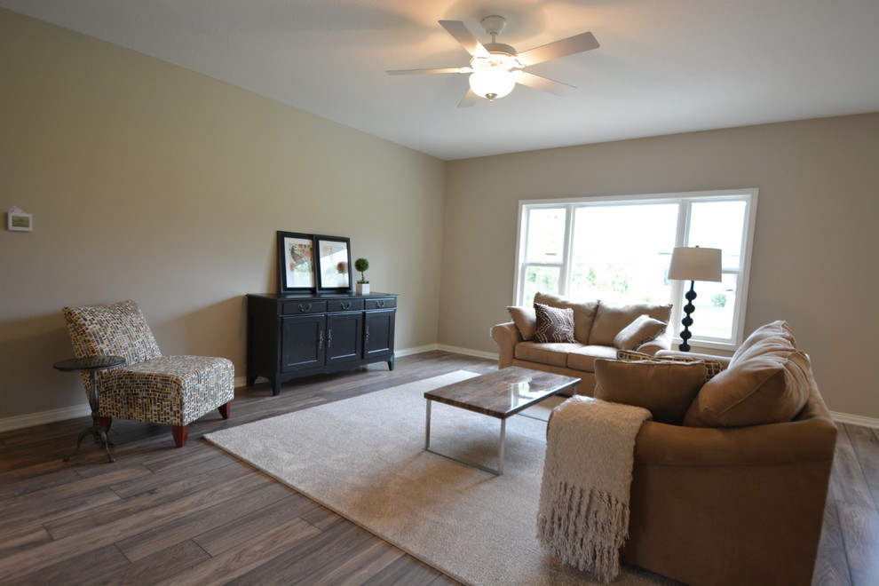 This is an example of a large traditional open concept family room in Other with beige walls, dark hardwood floors, no fireplace, no tv and brown floor.