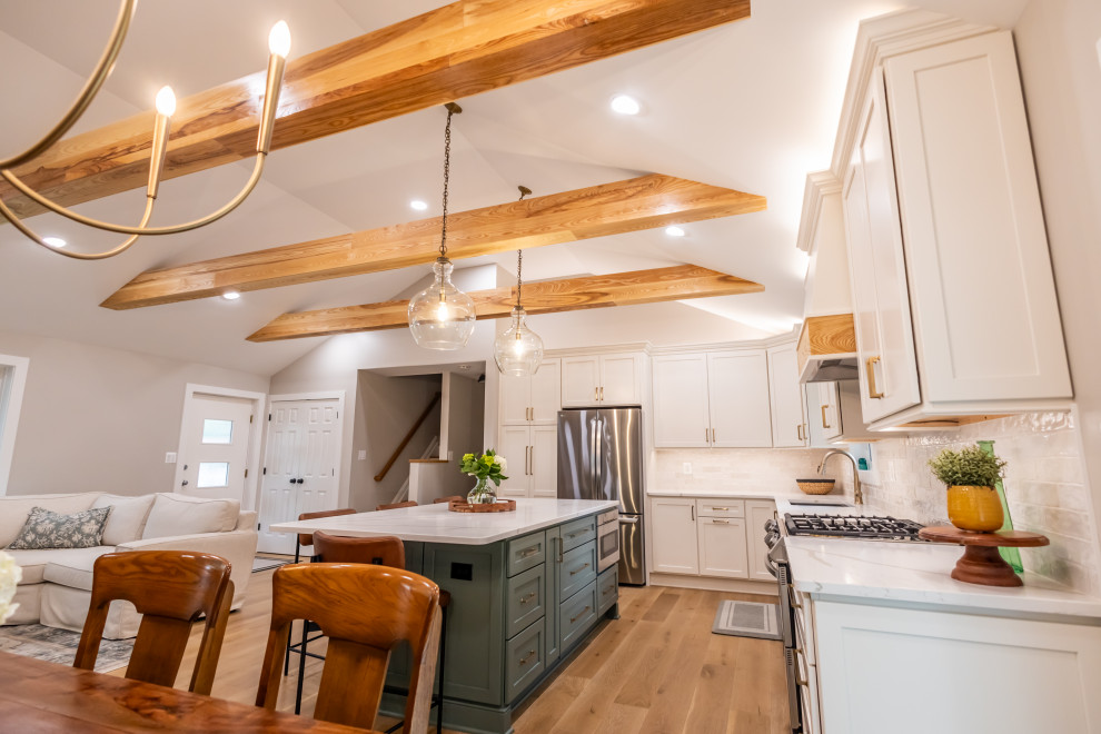 Inspiration for a large transitional l-shaped light wood floor, brown floor and exposed beam eat-in kitchen remodel in DC Metro with an undermount sink, shaker cabinets, quartz countertops, white backsplash, porcelain backsplash, stainless steel appliances, an island and white countertops