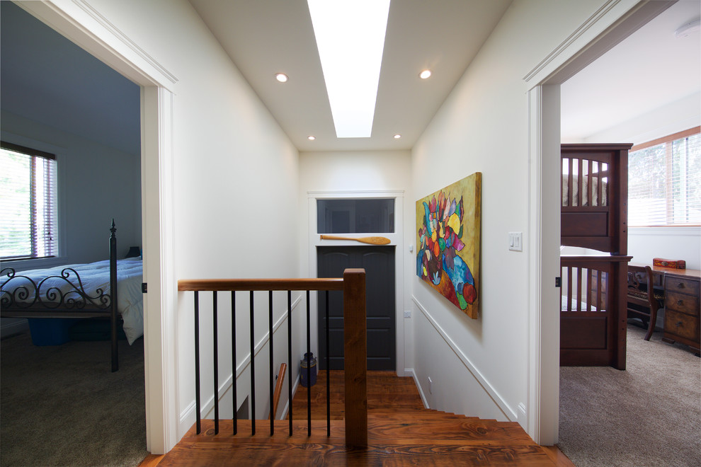 Inspiration for a mid-sized rustic medium tone wood floor hallway remodel in Vancouver with white walls