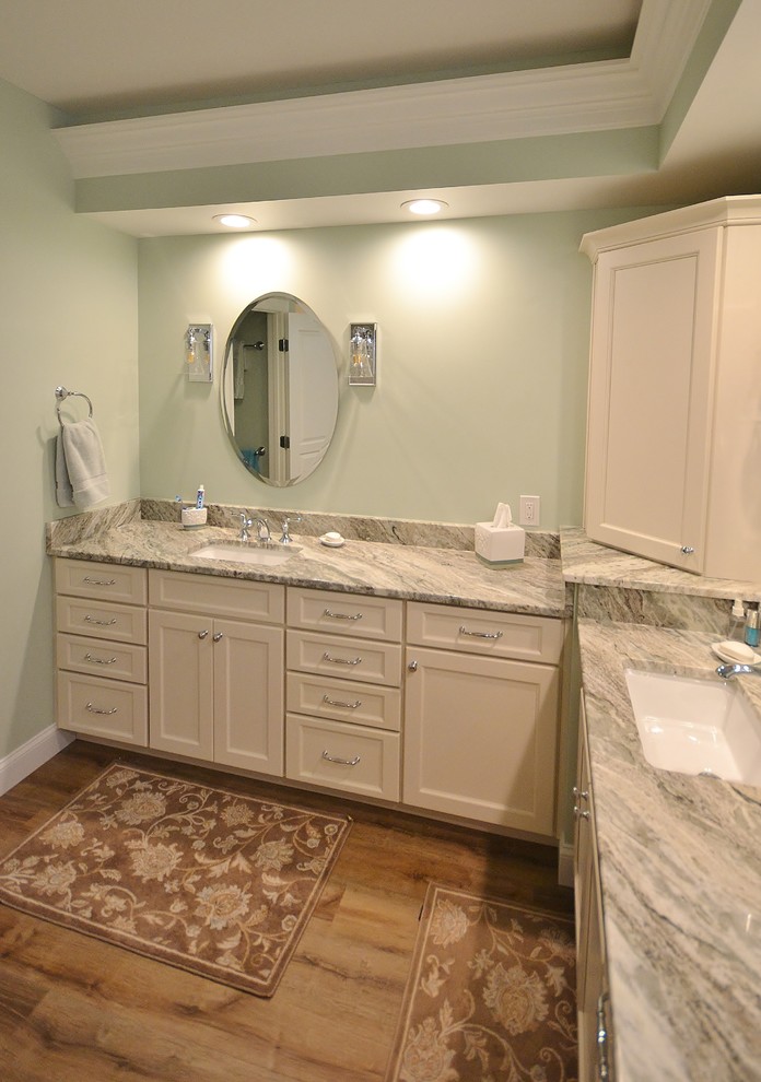 Inspiration for a large transitional master bathroom in Philadelphia with raised-panel cabinets, white cabinets, a corner shower, a one-piece toilet, beige tile, ceramic tile, vinyl floors, an undermount sink, granite benchtops, brown floor, a hinged shower door and multi-coloured benchtops.