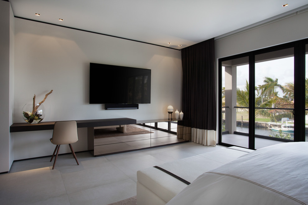 This is an example of an expansive contemporary guest bedroom in Miami with ceramic floors, white floor and grey walls.