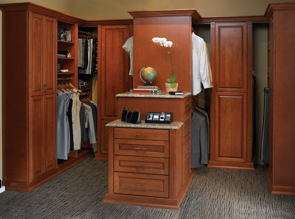 Large traditional gender-neutral dressing room in San Diego with raised-panel cabinets, dark wood cabinets and carpet.