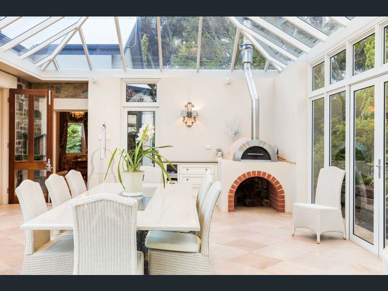 Great room - huge traditional terra-cotta tile and vaulted ceiling great room idea in Adelaide with a wood stove and a brick fireplace