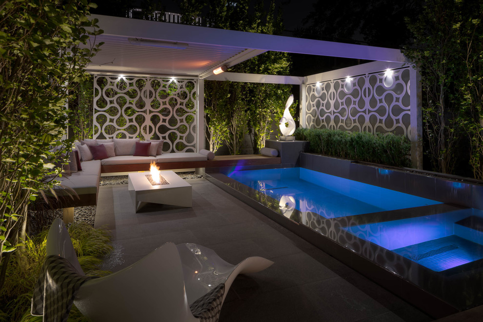 Inspiration for a small modern back patio in Toronto with natural stone paving and a gazebo.