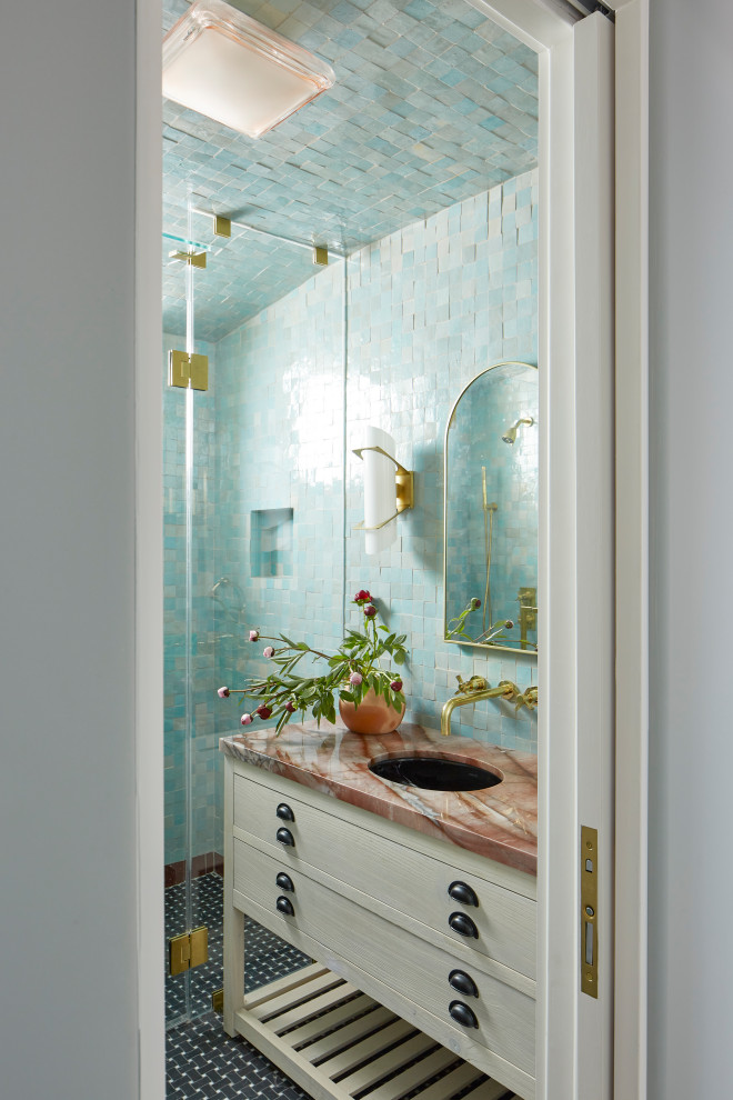 Walk-in shower - small mediterranean 3/4 terra-cotta tile and turquoise tile marble floor, black floor and single-sink walk-in shower idea in Los Angeles with light wood cabinets, blue walls, a drop-in sink, marble countertops, a hinged shower door, pink countertops and a freestanding vanity