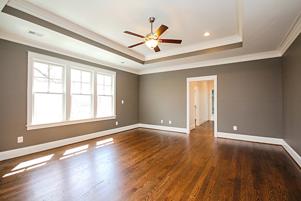 Photo of a large transitional master bedroom in DC Metro with brown walls, dark hardwood floors, no fireplace and brown floor.