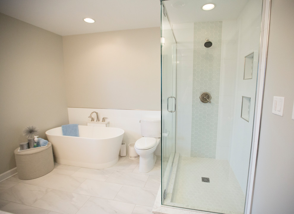 Photo of a transitional master bathroom in Chicago with raised-panel cabinets, medium wood cabinets, a freestanding tub, an open shower, a two-piece toilet, white tile, porcelain tile, porcelain floors, an undermount sink, engineered quartz benchtops, white floor and a hinged shower door.