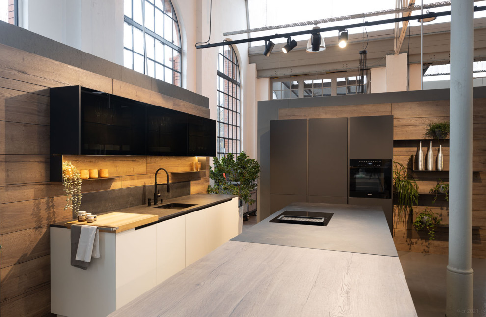This is an example of a contemporary kitchen in Dresden with with island.