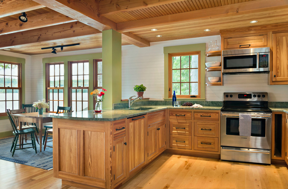 Inspiration for a small country u-shaped eat-in kitchen in Boston with an undermount sink, flat-panel cabinets, light wood cabinets, granite benchtops, green splashback, stone slab splashback, stainless steel appliances and light hardwood floors.