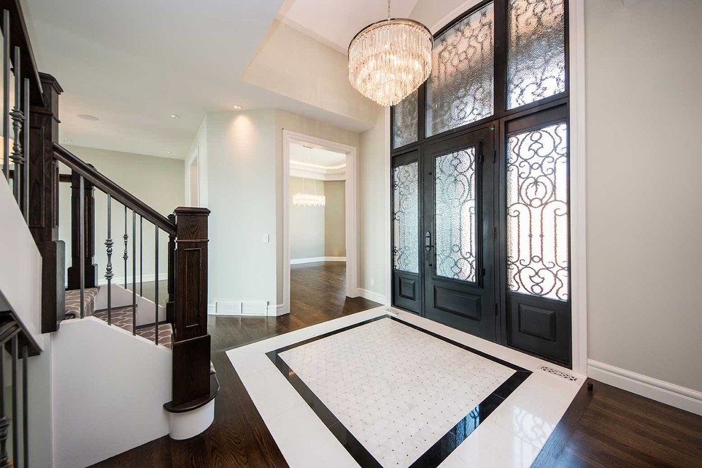 Large transitional porcelain tile and multicolored floor foyer photo in Calgary with gray walls and a metal front door