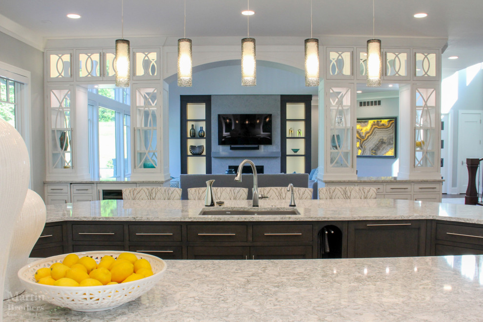 Kitchen pantry - huge transitional l-shaped dark wood floor kitchen pantry idea with an undermount sink, shaker cabinets, white cabinets, quartzite countertops, gray backsplash, ceramic backsplash, stainless steel appliances and two islands