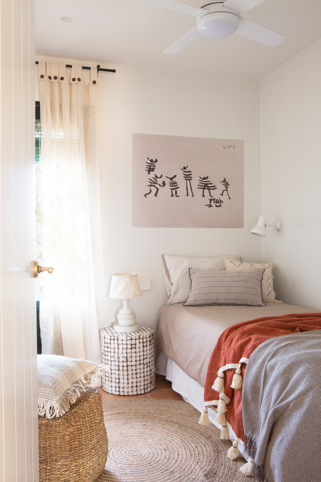 Diseño de habitación de invitados de estilo de casa de campo con paredes blancas, suelo de baldosas de terracota y suelo marrón