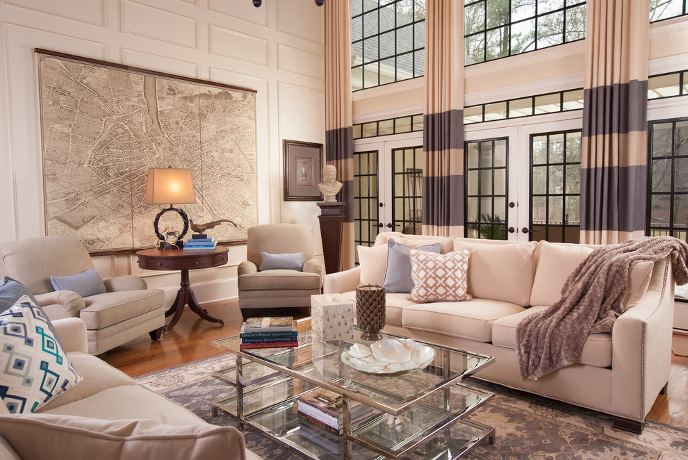 Photo of a large transitional formal open concept living room in Atlanta with beige walls, medium hardwood floors, a standard fireplace and brown floor.