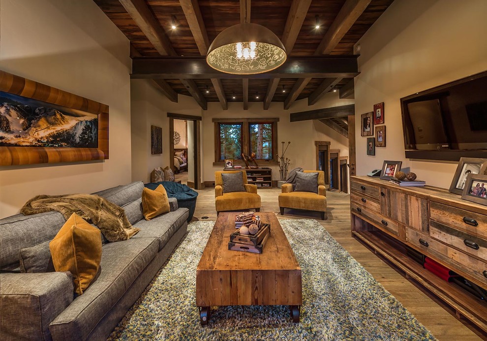 Photo of a country open concept living room in Sacramento with brown walls, dark hardwood floors and a wall-mounted tv.