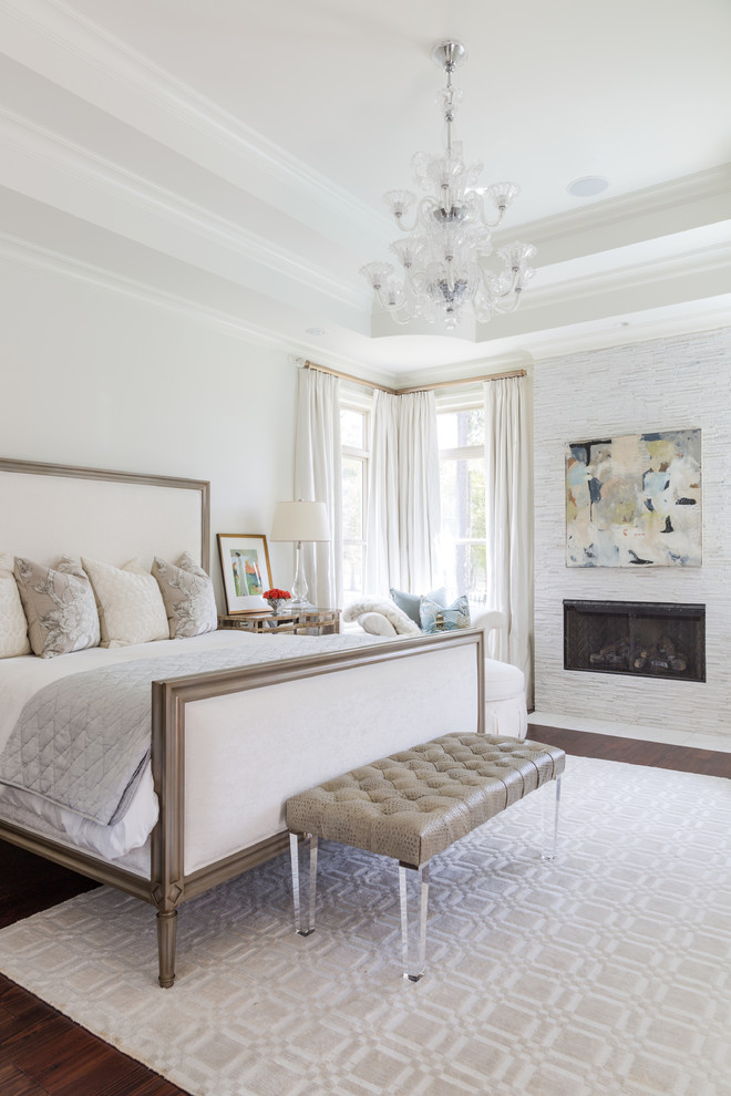 Design ideas for a large traditional master bedroom in New Orleans with white walls, dark hardwood floors and a ribbon fireplace.