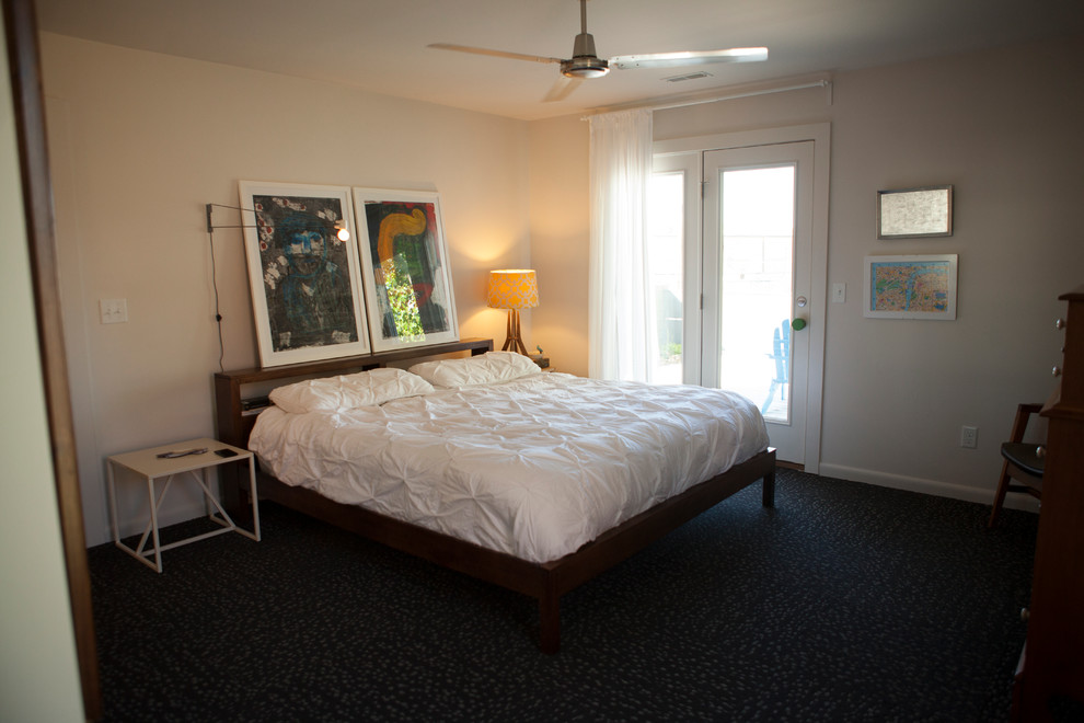This is an example of a contemporary master bedroom in St Louis with carpet.