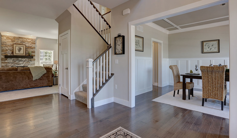 Inspiration for a large traditional foyer in Other with beige walls, medium hardwood floors and a single front door.