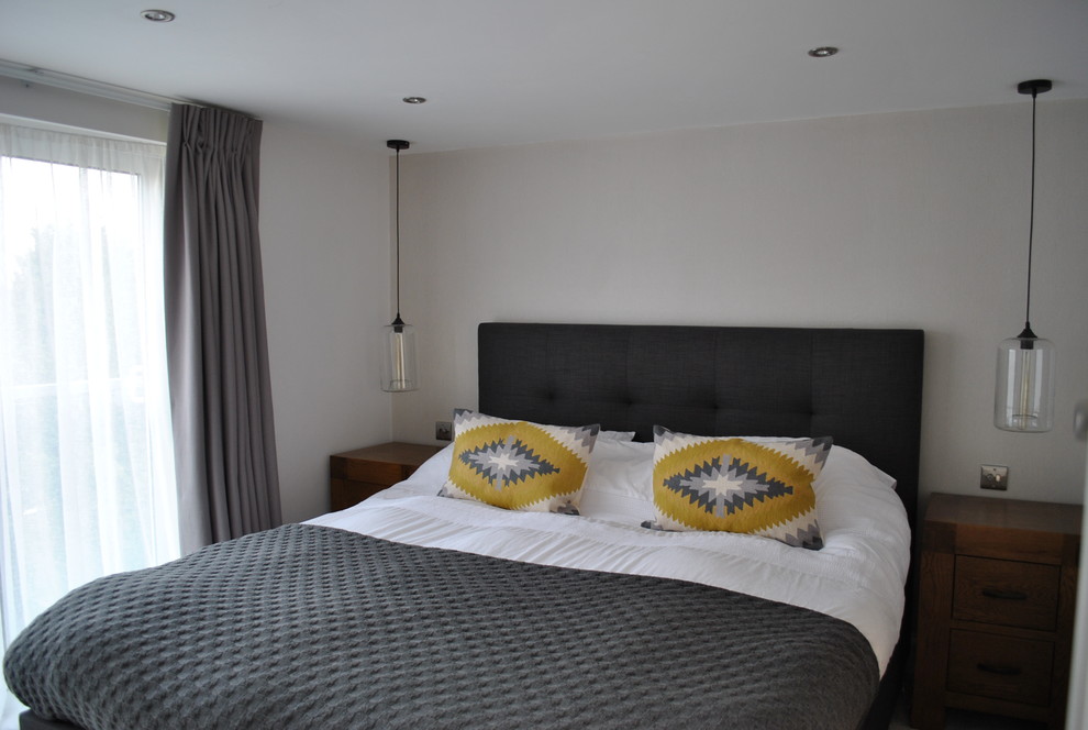 Contemporary master bedroom in Hertfordshire with grey walls.