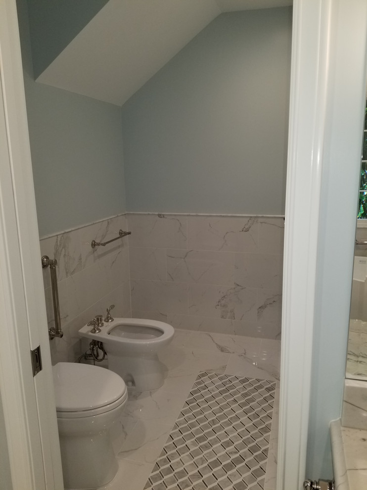 Design ideas for a midcentury ensuite bathroom in Tampa with recessed-panel cabinets, dark wood cabinets, a freestanding bath, a built-in shower, a bidet, black and white tiles, marble tiles, grey walls, marble flooring, a built-in sink, marble worktops, white floors, a hinged door, white worktops, an enclosed toilet, double sinks and a built in vanity unit.