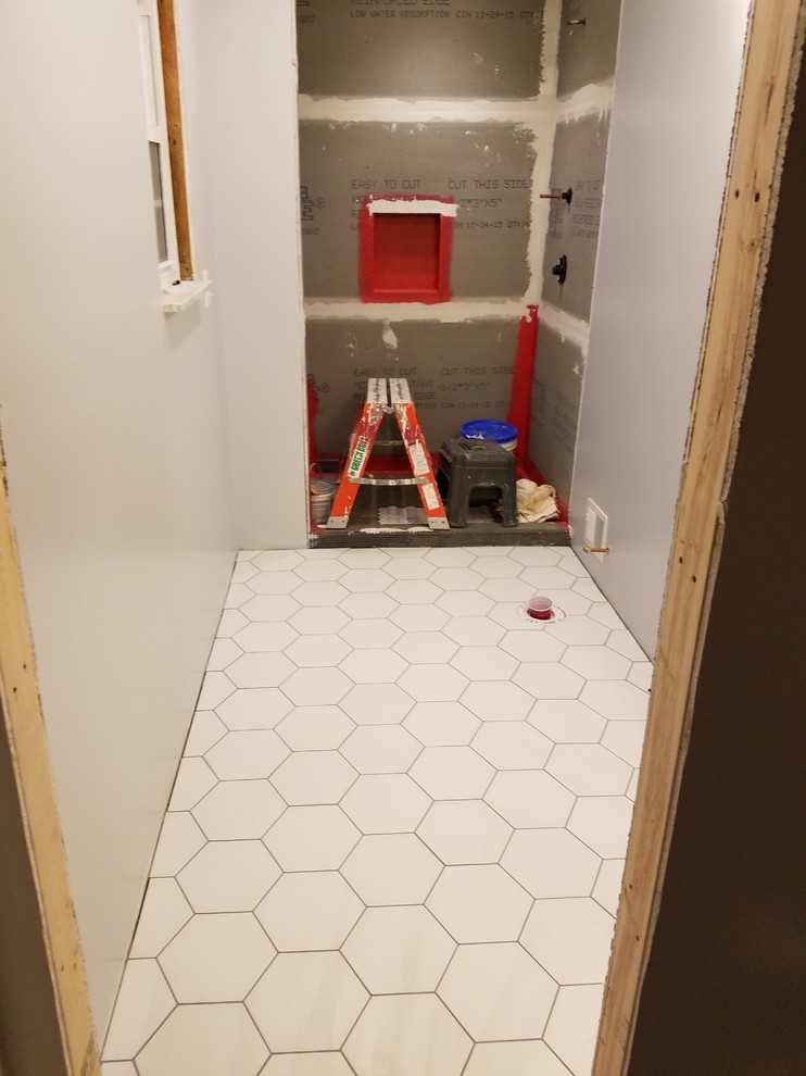 Inspiration for a small transitional 3/4 blue tile and glass tile porcelain tile alcove shower remodel in Cincinnati with recessed-panel cabinets, black cabinets, a two-piece toilet, gray walls, an undermount sink and quartz countertops