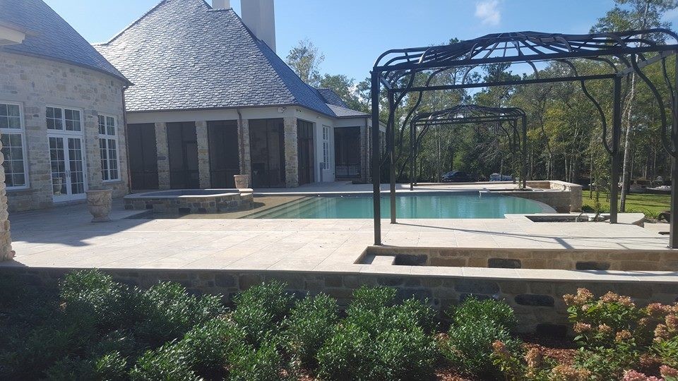 Large transitional backyard brick patio fountain photo in Miami with no cover