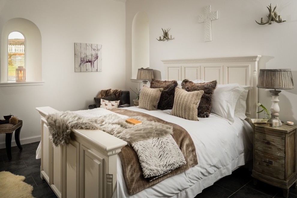 Inspiration for a mid-sized country guest bedroom in Other with white walls, slate floors and grey floor.