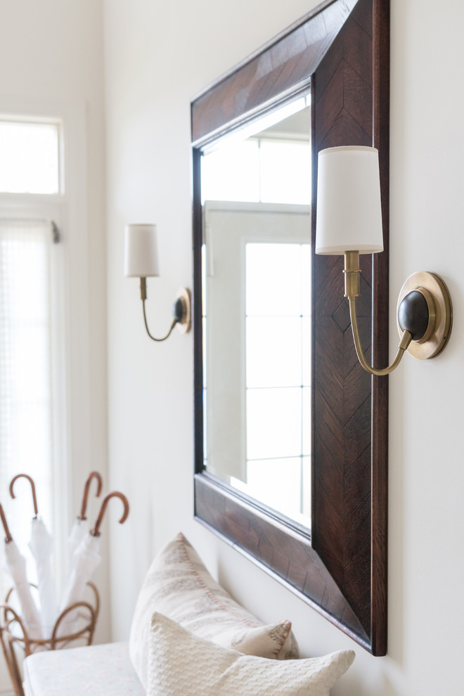 Example of a large transitional ceramic tile foyer design in New York with white walls and a white front door