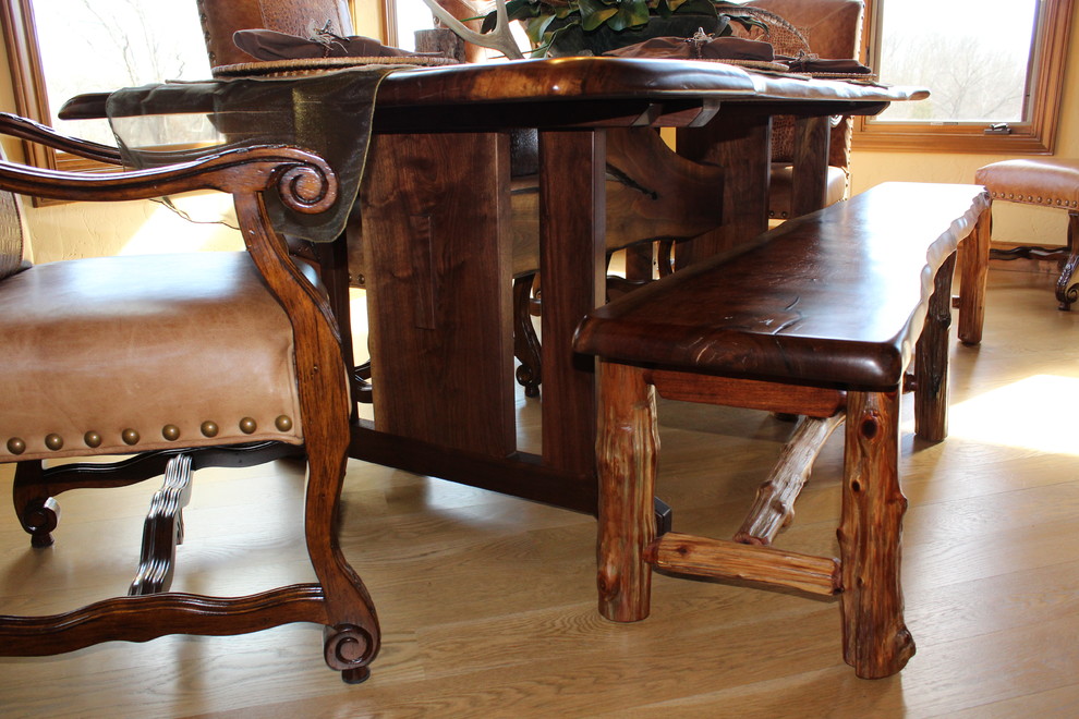 Mid-sized mountain style light wood floor and brown floor enclosed dining room photo with brown walls and no fireplace