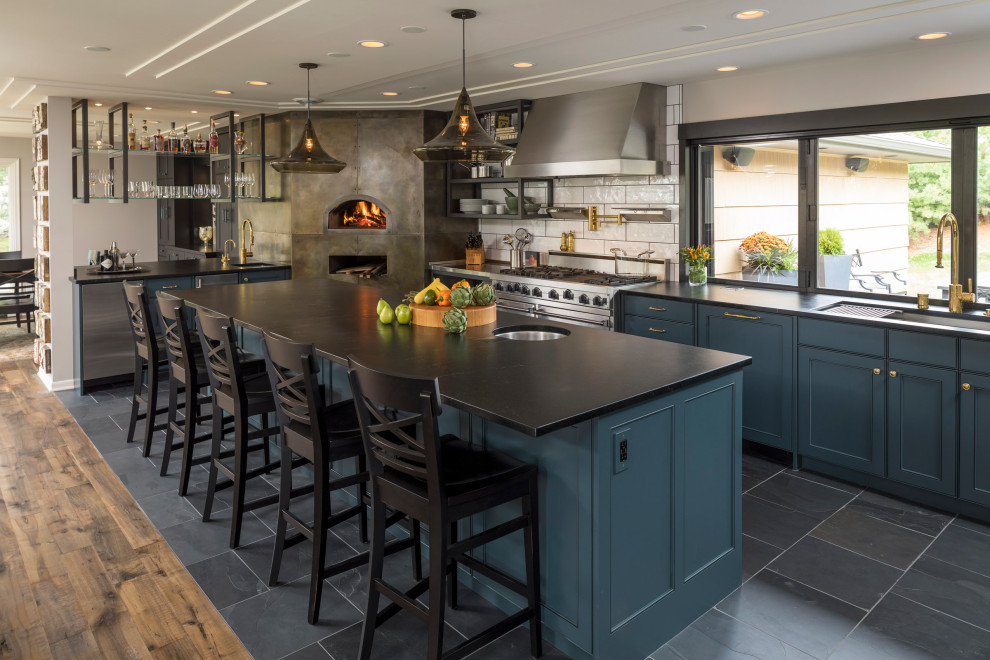 Design ideas for a contemporary kitchen in Minneapolis with blue cabinets, soapstone benchtops, stainless steel appliances, with island and black benchtop.