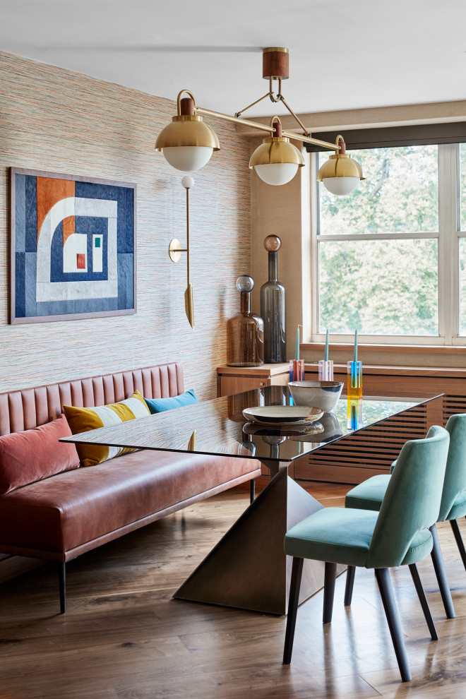 This is an example of a mid-sized midcentury open plan dining in London with multi-coloured walls, medium hardwood floors and brown floor.