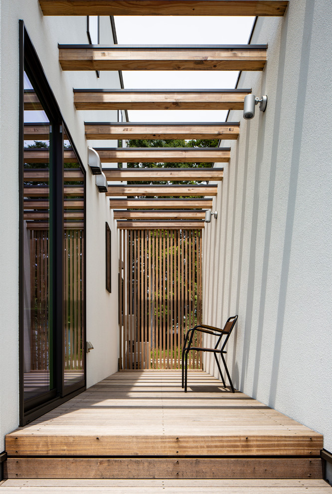 Design ideas for an asian side yard deck in Tokyo with a pergola.