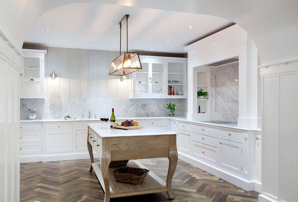 Inspiration for a large eclectic u-shaped kitchen pantry in Dublin with a single-bowl sink, beaded inset cabinets, white cabinets, marble benchtops, white splashback, stone slab splashback, stainless steel appliances, dark hardwood floors and with island.