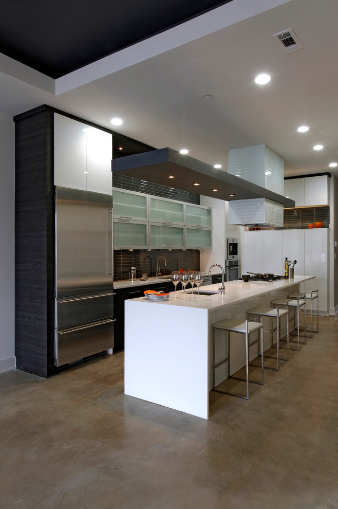 Mid-sized modern galley eat-in kitchen in DC Metro with an undermount sink, flat-panel cabinets, dark wood cabinets, quartzite benchtops, grey splashback, glass tile splashback, stainless steel appliances, with island, concrete floors and beige floor.