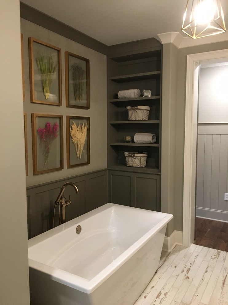 Photo of a mid-sized country master bathroom in Other with recessed-panel cabinets, grey cabinets, a freestanding tub, an alcove shower, white tile, porcelain tile, grey walls, painted wood floors, an undermount sink, engineered quartz benchtops, white floor and a hinged shower door.
