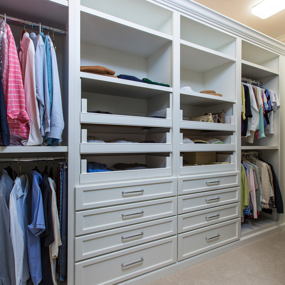 Photo of a large transitional gender-neutral walk-in wardrobe in Miami with flat-panel cabinets, white cabinets and carpet.