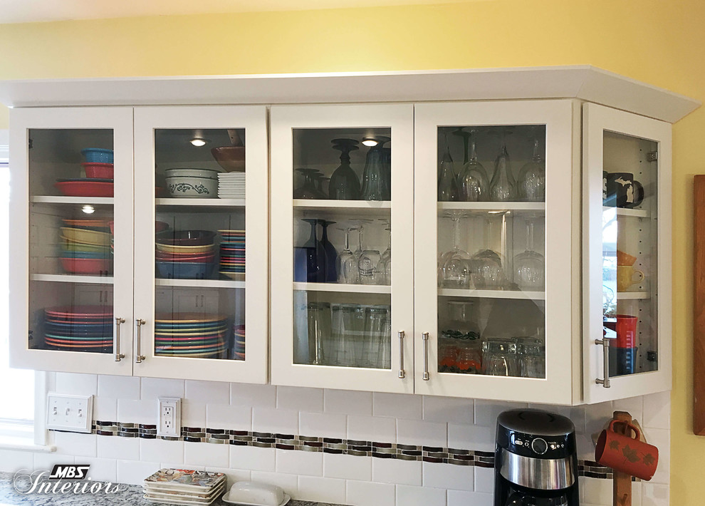 Huge transitional u-shaped medium tone wood floor and brown floor eat-in kitchen photo with an undermount sink, shaker cabinets, white cabinets, granite countertops, white backsplash, subway tile backsplash, stainless steel appliances and an island
