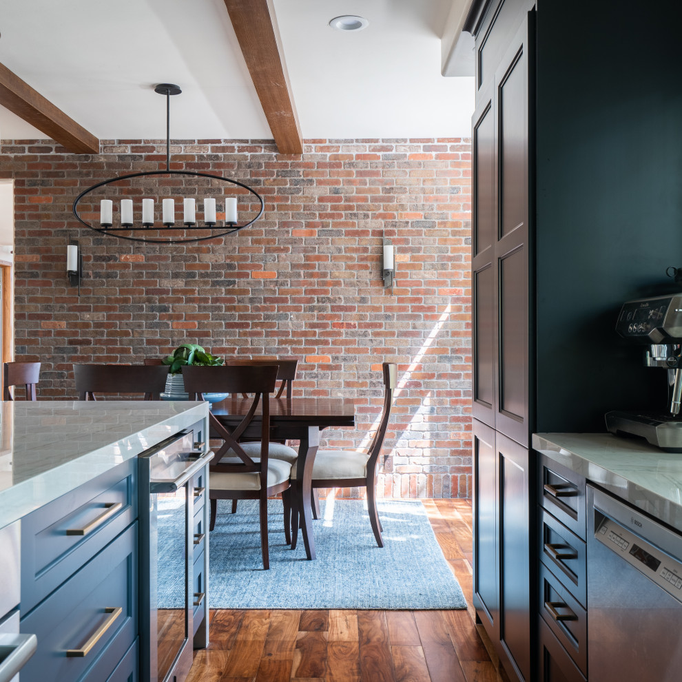Example of a mid-sized transitional l-shaped dark wood floor, brown floor and exposed beam open concept kitchen design in Denver with an undermount sink, recessed-panel cabinets, black cabinets, quartz countertops, blue backsplash, ceramic backsplash, stainless steel appliances, an island and white countertops
