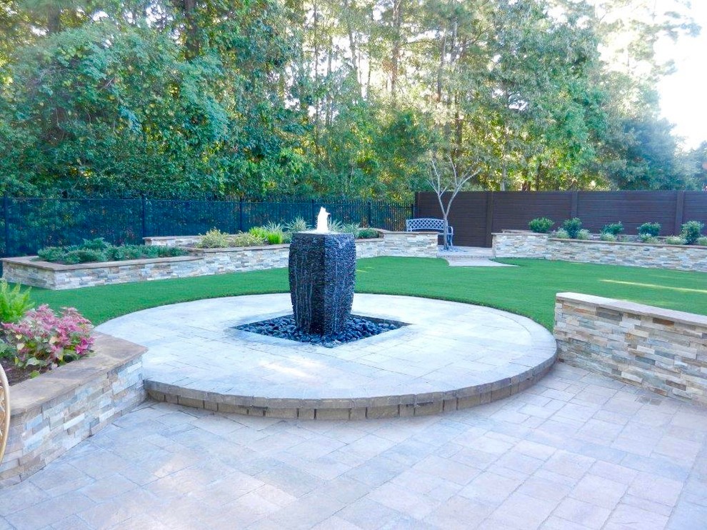 Traditional backyard patio in Houston with a water feature, brick pavers and no cover.