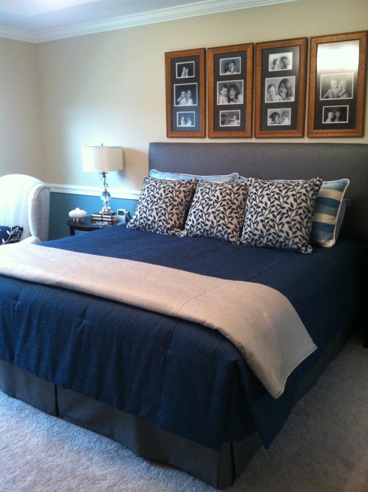Large transitional master bedroom in Cleveland with beige walls and carpet.