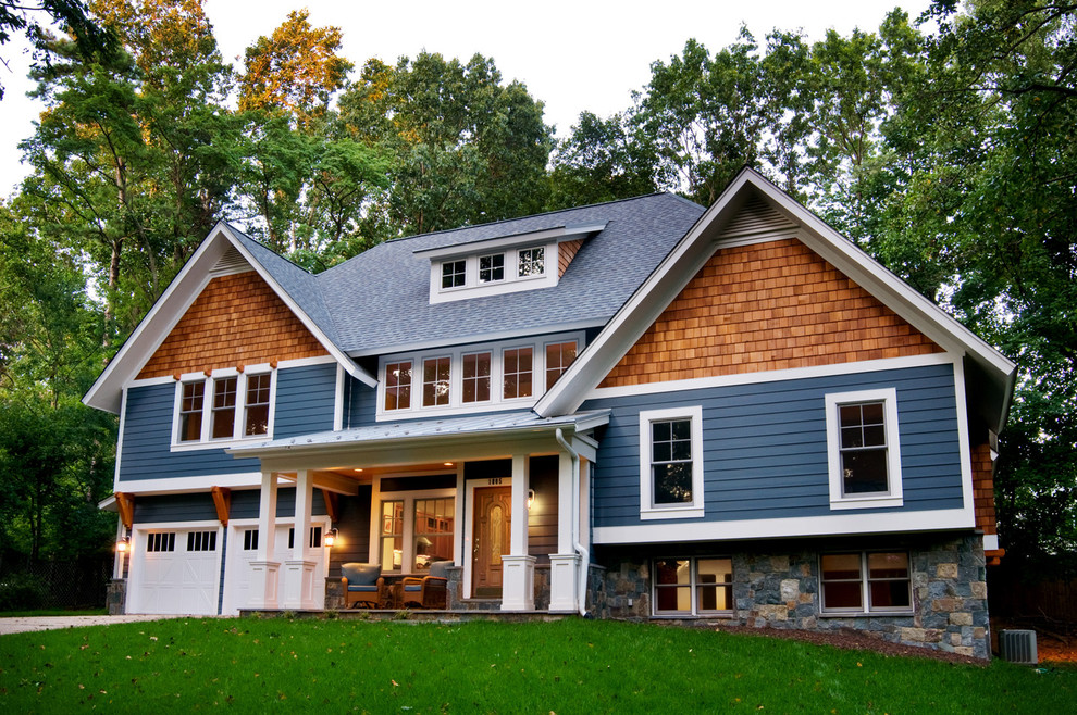 Inspiration for an arts and crafts two-storey exterior in DC Metro with wood siding.