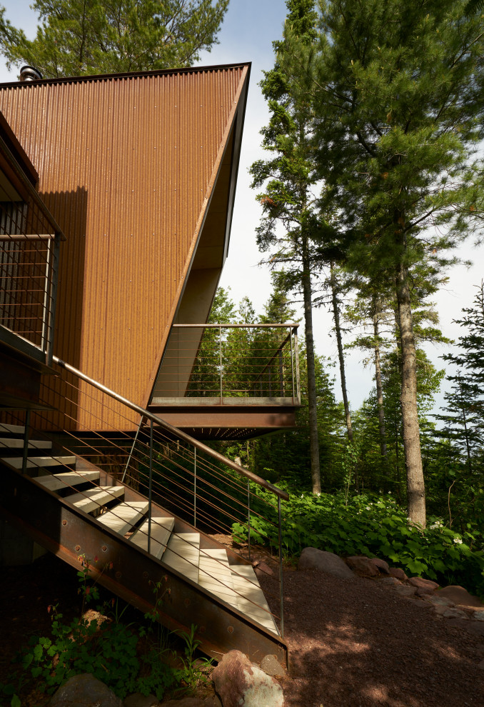 Inspiration for a rustic backyard metal railing deck remodel in Seattle with a roof extension