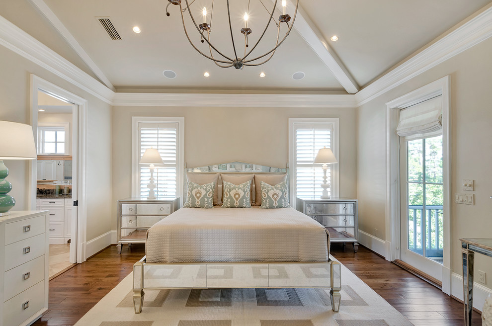 This is an example of a mid-sized beach style master bedroom in Miami with beige walls and medium hardwood floors.