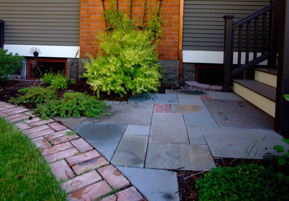 Small traditional side yard patio in Portland with brick pavers and no cover.