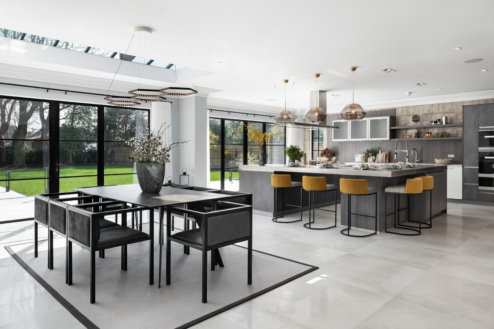 This is an example of a large contemporary kitchen/dining combo in Buckinghamshire with no fireplace and grey floor.