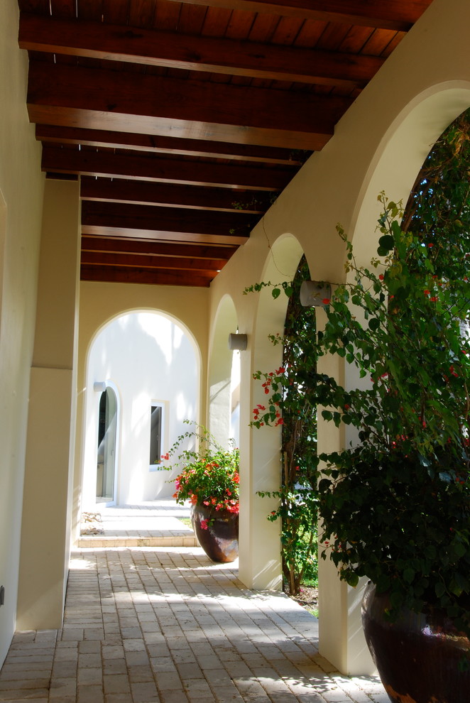 Example of a large brick floor hallway design in Miami with beige walls